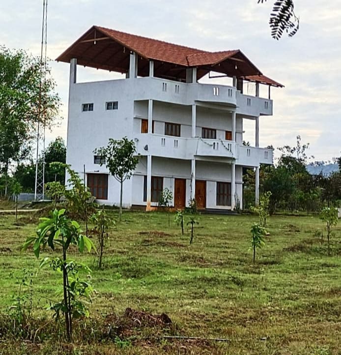 Trees and open ground at the monastery site near Mysore.